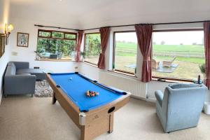 a living room with a pool table in it at The wellbeing XCAPE Country Barn PT & Masseur - H in Nuneaton