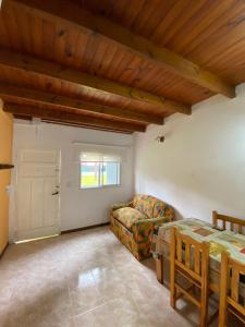 a living room with a couch and a table at CABAÑA EN EL BOSQUE CENTRICA in Costa del Este