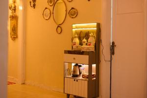a small cabinet with a mirror in a room at Le Caire Guest Houes Cairo in Cairo