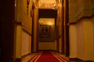 a hallway with a picture of a woman on the wall at Le Caire Guest Hous cairo in Cairo