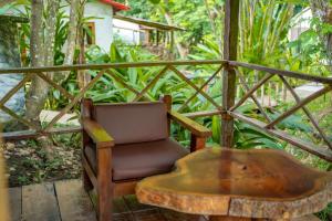 a chair and a wooden table with a wooden table at Hotel Cabañas Safari in Palenque