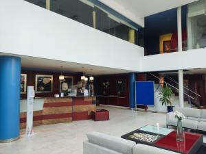a lobby with couches and a bar in a building at Hotel Torresport in Torrelavega +33 photos