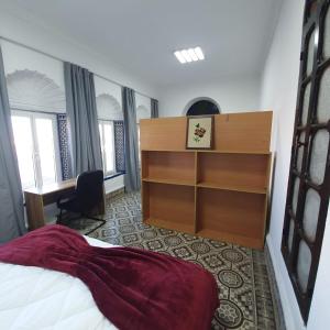 a hotel room with a bed and a desk at Riad Apartment with Panoramic Bouregreg & Marina View in Rabat