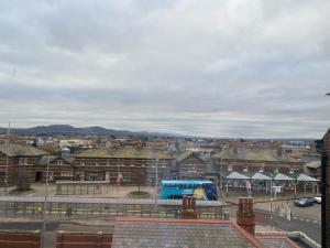 a view of a city with a blue bus at Aisha’s Attic in Rhyl