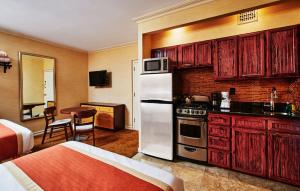 a kitchen with red cabinets and a white refrigerator at Radio City Apartments in New York