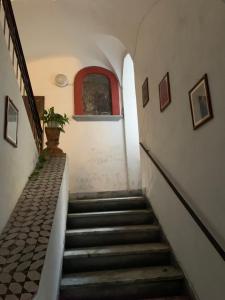 a staircase in an old building with a window at Rosa Magra Guest House in Sorrento