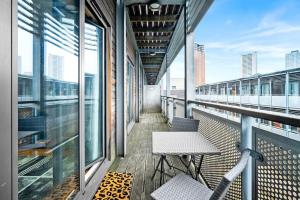 a balcony with two chairs and windows on a building at Cozy 2 Bed Arcadian Center By Azura Nights in Birmingham