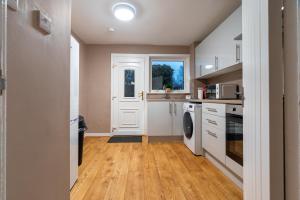 a kitchen with a washer and dryer at Kingswood in Bishopton