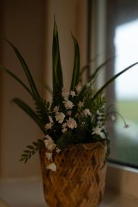 a basket with flowers in it sitting on a table at Kingswood in Bishopton