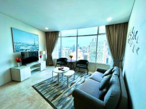 a living room with a couch and a large window at Vortex suites KLCC By Moonlight in Kuala Lumpur