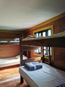 a room with three bunk beds in a room at Casa para 12 personas Acceso a la represa y Barbacoa in Guatapé
