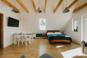 a bedroom with a bed and a table and a dining room at Apart House Karwia & Wellness in Karwia