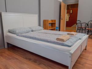 a bed in a room with a white bed frame at DeeP Guest House in Budapest