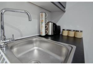 a kitchen counter with a sink in a kitchen at Charming 1BR flat in Maidstone in Maidstone