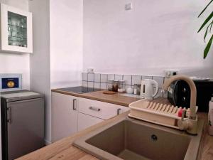 a kitchen with a sink and a mixer on a counter at Great Apart Mokotów in Warsaw