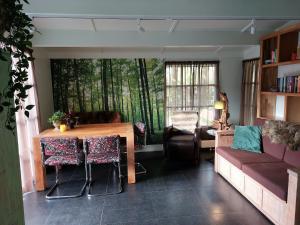 a living room with a table and a couch at Villa Mar veluwe in Ermelo