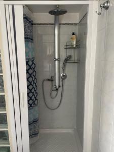 a shower with a hose in a bathroom at B&B Trieste&Trento in Naples