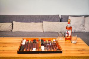 a table with a bottle of beer and a tray of guns at Villa Makeli in Rogachevo