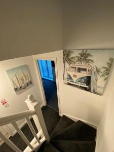 a stairway with a picture of a bus on the wall at Huge 6 Bed house & 6 Bathrooms. in Boston