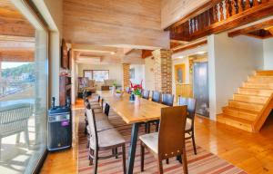 a dining room with a long table and chairs at Villa Makeli in Rogachevo