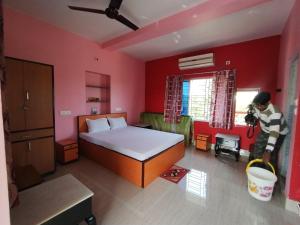 a person taking a picture of a bedroom at Muktomon Hotel & Resort in Bolpur