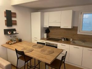 a kitchen with a wooden table and some chairs at Casina Cesena in Cesena