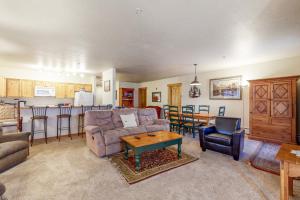 a living room with a couch and a table and a kitchen at Tenderfoot Lodge 2652 in Keystone