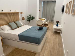 a bedroom with a bed and a table and a dining room at Travel Habitat Cabanyal Lofts in Valencia