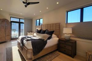 a bedroom with a large bed with black pillows at Mahar Homes - Plaza North on First in Ashland