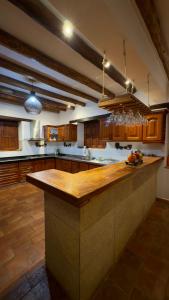 a large kitchen with a large island in the middle at Hotel Palais Barichara in Barichara