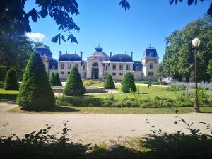 a large building with a garden in front of it at LE NODIER in Lons-le-Saunier
