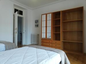 1 dormitorio con 1 cama y un gran armario de madera en Apartamentos Turísticos La Solana, en Colombres