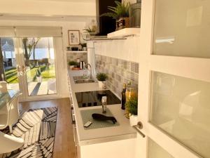 a tiny house with a sink and a window at Seaview Cottage on the Island 