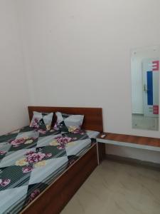 a bedroom with a bed with flowers on it at Shiv Shakti Palace in Rīngas