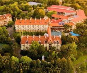 an aerial view of a large building with orange roofs at Suite Confort - Gramado Wish Serrano in Gramado