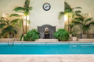 a pool in a building with a clock on the wall at Loi Suites Recoleta Hotel in Buenos Aires