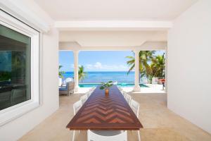 a dining room with a table and a view of the ocean at Ocean Kai home in Driftwood Village