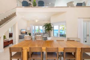 a dining room with a wooden table and chairs at Ocean Kai home in Driftwood Village
