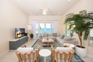 a living room with a couch and a table at Ocean Kai home in Driftwood Village