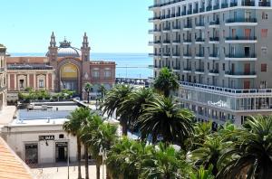 a view of a city with palm trees and a building at Bari LandLord 71 - Central Rooms in Bari