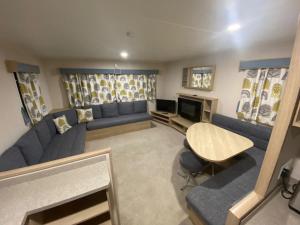 a living room with blue couches and a table at The Link Inn in Allhallows +6 photos