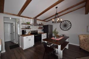 a kitchen with white cabinets and a table in it at Bliss on the Lake in Wausau