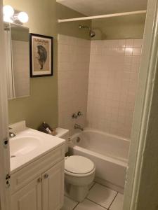 a bathroom with a toilet and a tub and a sink at Private room with full size bed in Lakeview - 3c in Chicago