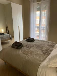 a bedroom with a large bed with two towels on it at A Casa di Katia in Collegno