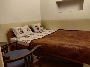 A bed or beds in a room at Natraj Guest House