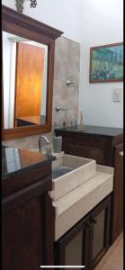 a bathroom with a sink and a mirror at El Inti in San Fernando del Valle de Catamarca