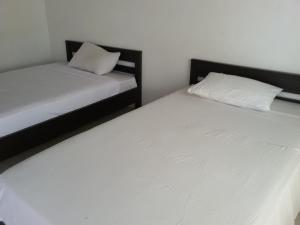 Postel nebo postele na pokoji v ubytování Syifa Homestay