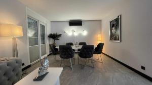 a living room with a dining room table and chairs at Apartman Emel in Bodrum City