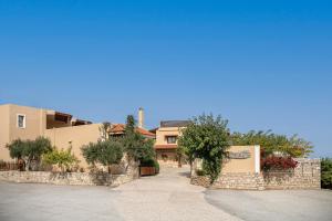 a house with a stone wall next to a street at Earino in Kato Asites