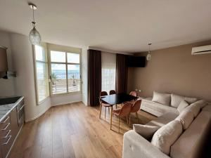 a living room with a couch and a table at Wave Beachfront Apartments in Durrës